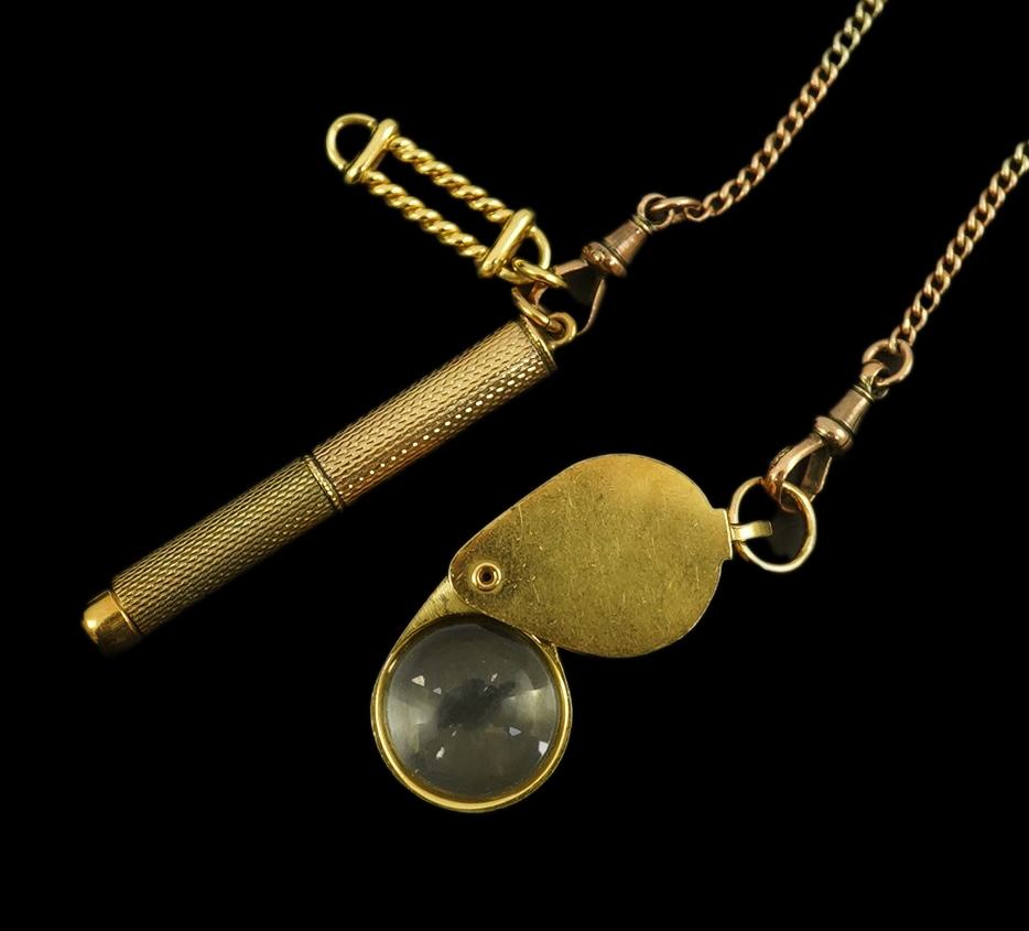 A modern 18ct gold mounted jeweller's loupe, 24mm and a 9ct gold cased propelling toothpick, both suspended from a two colour 9ct gold chain